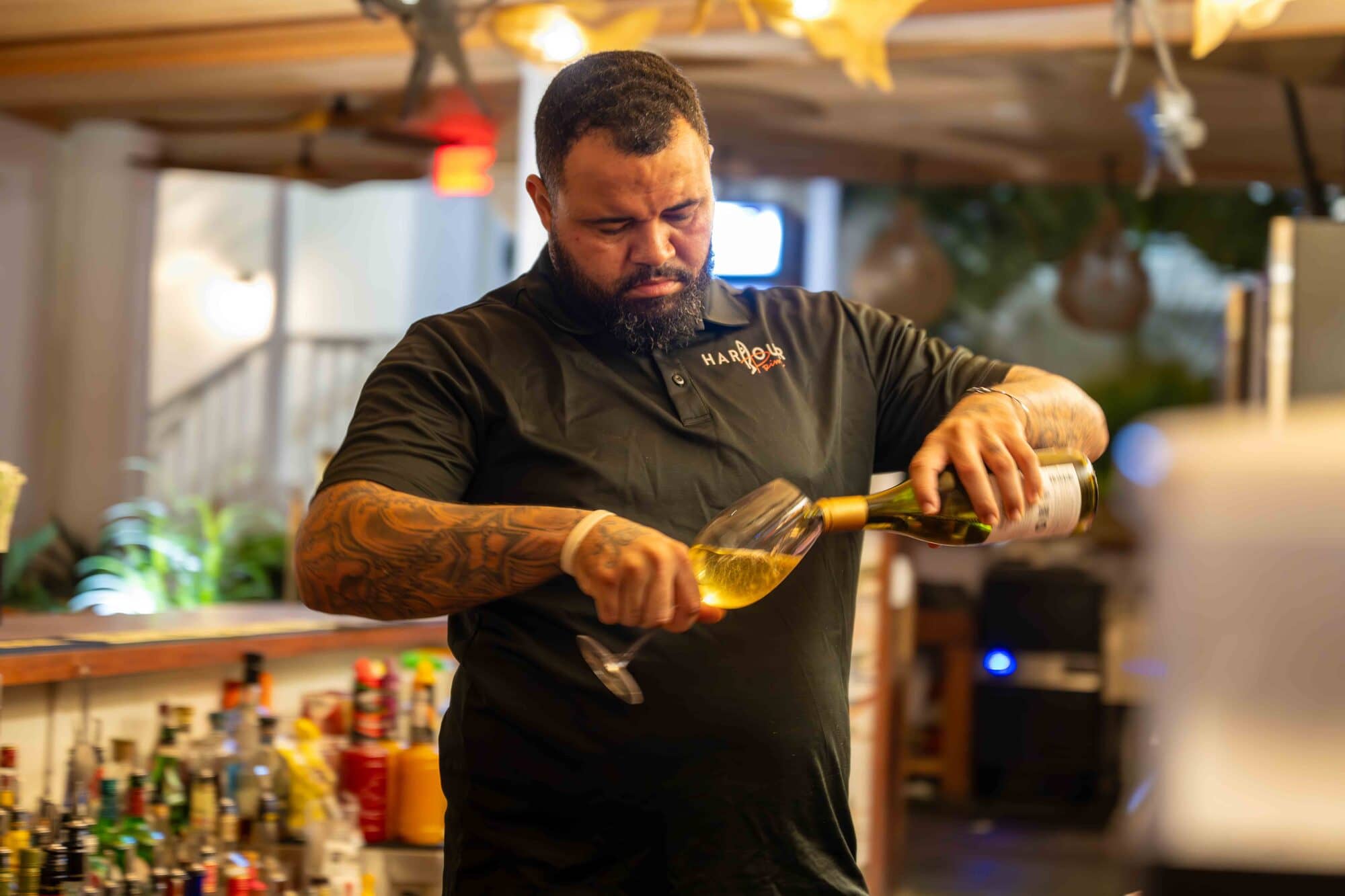 A bartender pouring wine at Harbour Prime