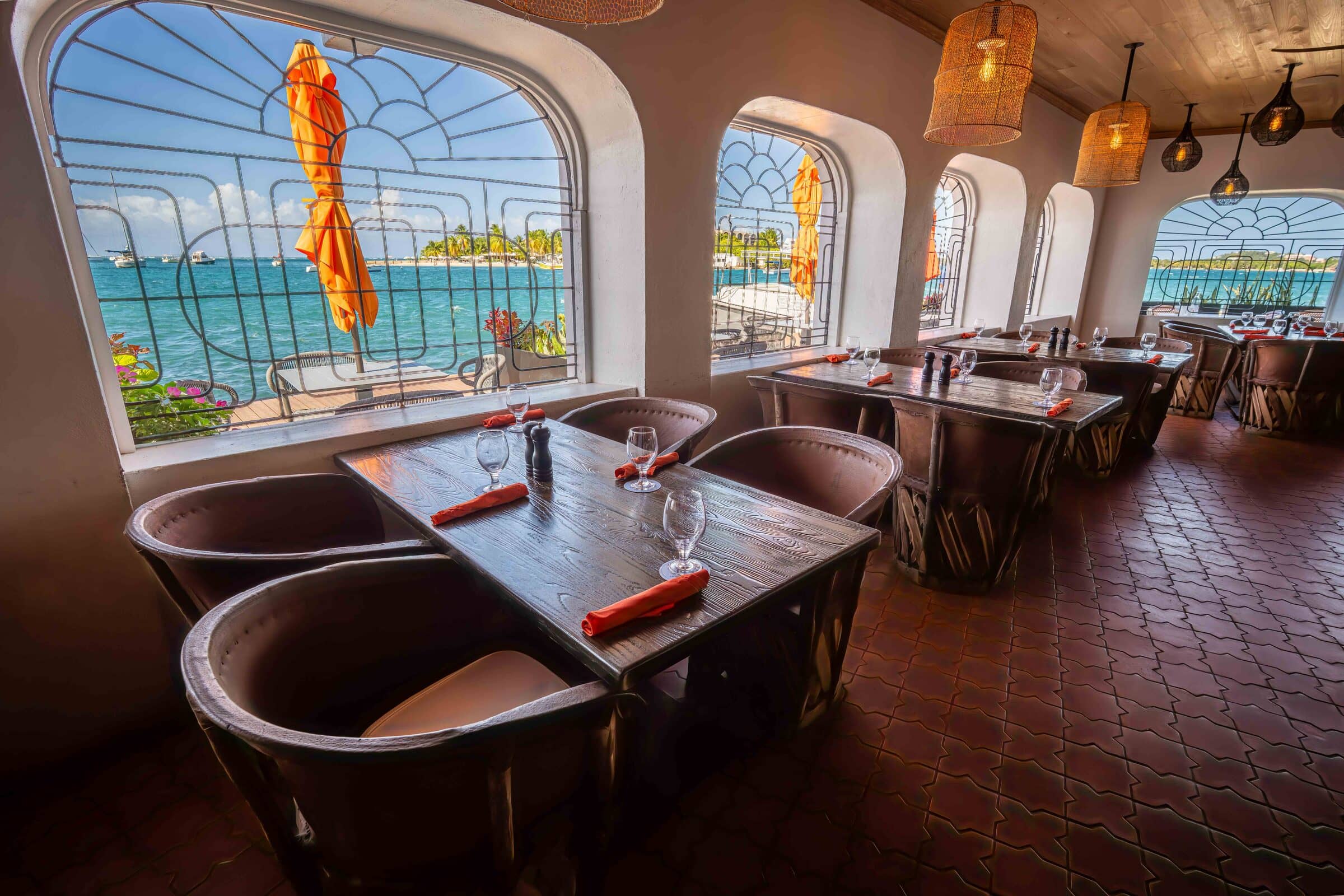 Dining room at Harbour Prime with arched windows framing the Christiansted harbor