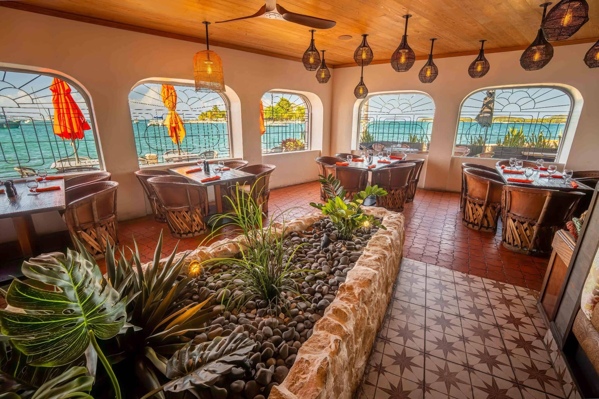 The waterfront dining room at Harbour Prime, with arched windows overlooking the Christiansted harbor