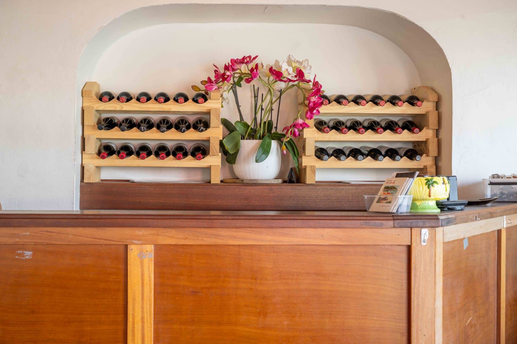 Wine display with a fresh orchid at Harbour Prime